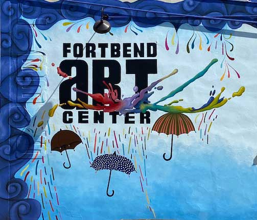 Fort Bend Art Center paint splash logo with umbrellas. Mural by Cisco and photo by Photos by Don.